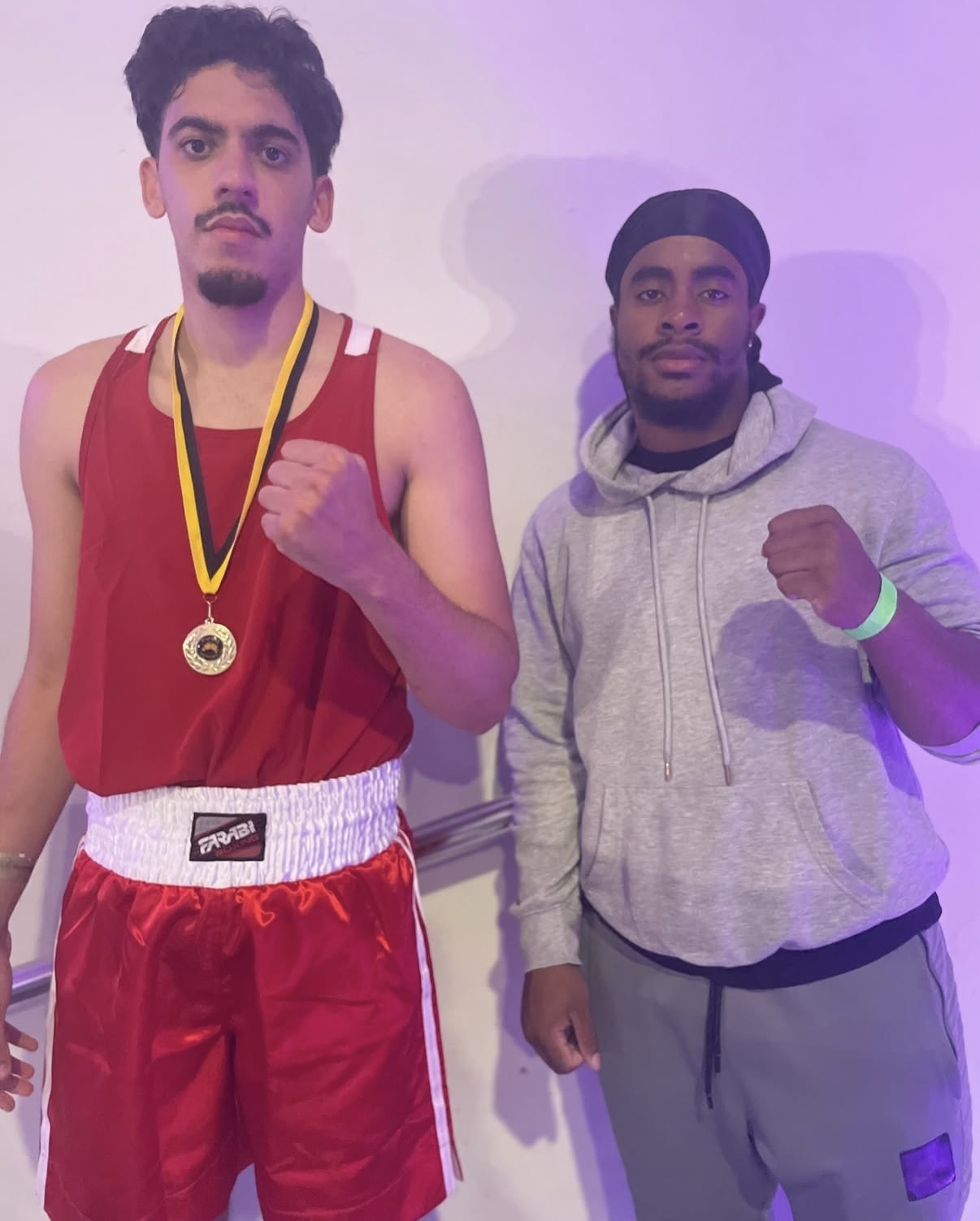 Medal-winning fighter with Coach Leonardo after his bout