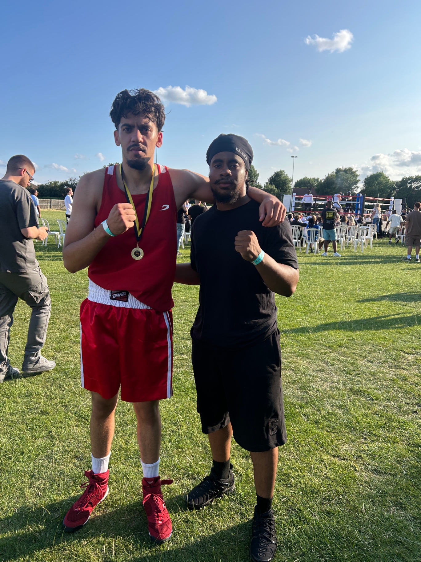 Coach with a medal-winning fighter at an outdoor show