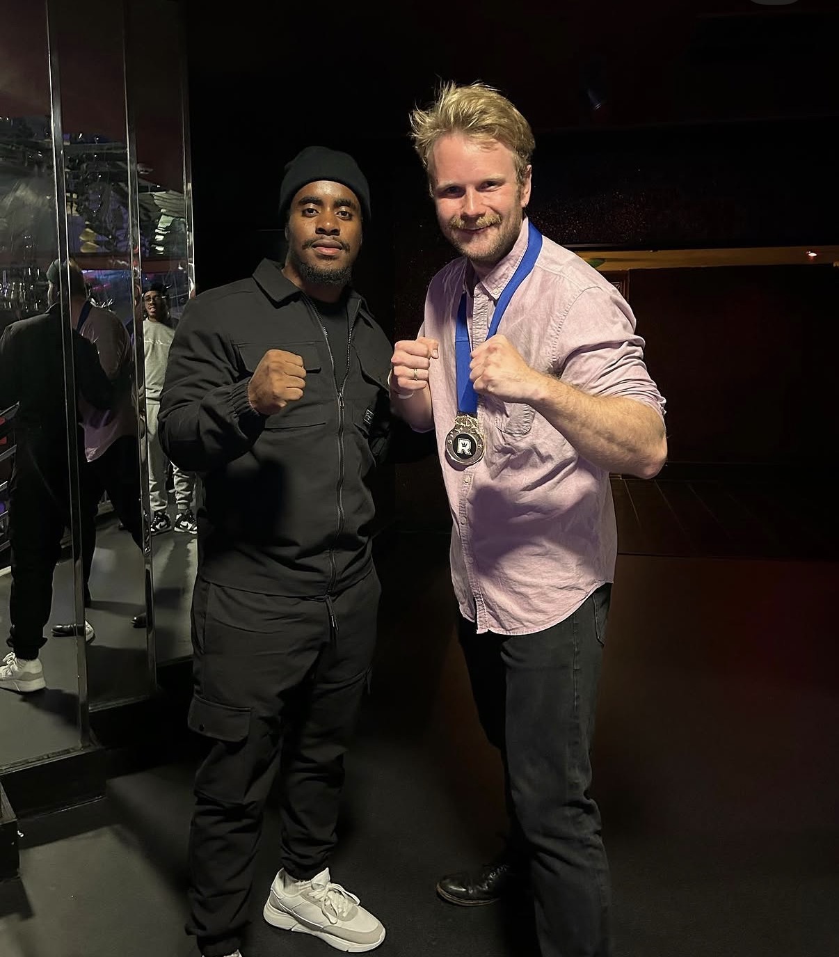 Coach Leonardo with a winning fighter backstage